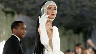 Katy Perry wearing a white shaped gown and long gloves